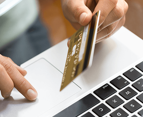 Closeup of credit card and laptop.