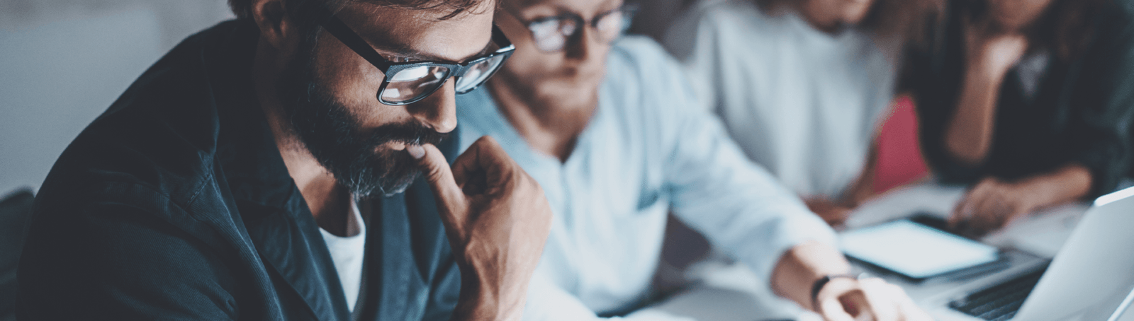 People concentrating on a computer task.